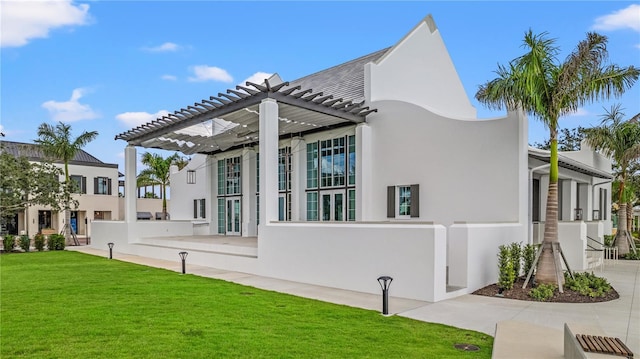 view of home's exterior with a yard and a pergola