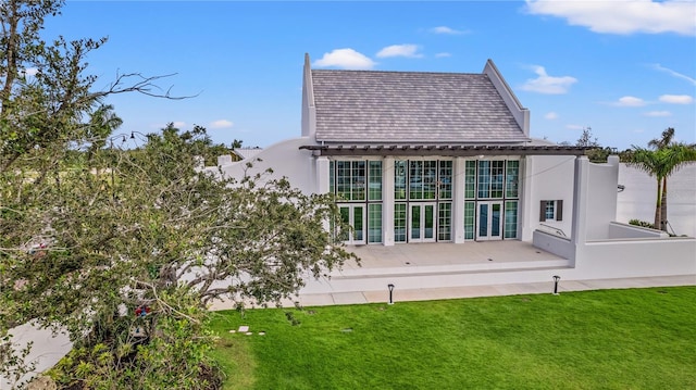 back of property featuring french doors, a yard, and a patio area