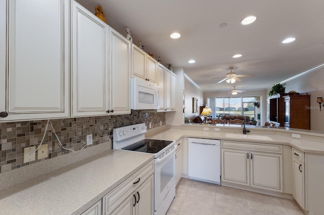 kitchen featuring sink, crown molding, white appliances, light tile patterned floors, and decorative backsplash