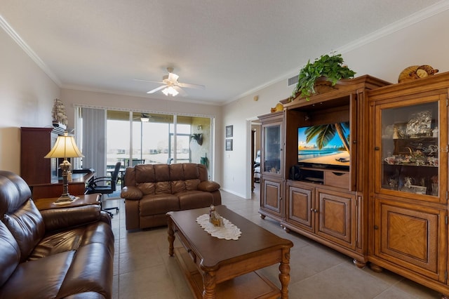 living room with light tile patterned floors, crown molding, and ceiling fan