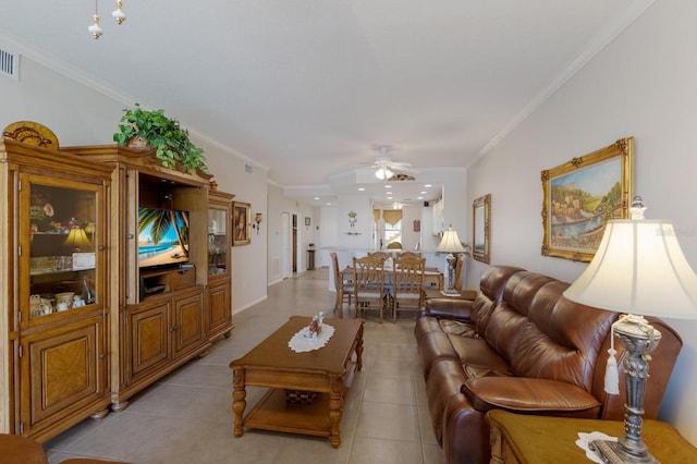 tiled living room featuring crown molding and ceiling fan