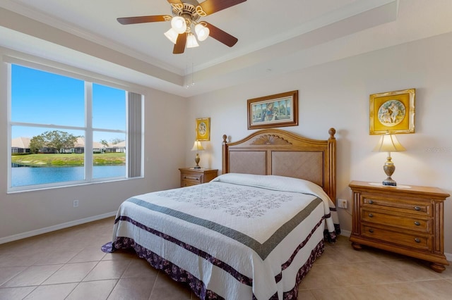 tiled bedroom with a raised ceiling, crown molding, a water view, and ceiling fan