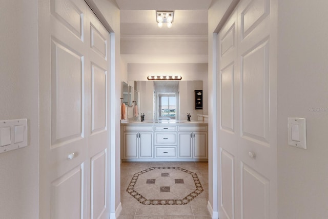 bathroom with ornamental molding, vanity, and tile patterned floors