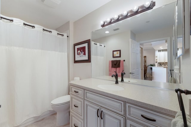 bathroom featuring tile patterned floors, toilet, and vanity