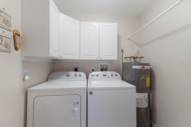 clothes washing area featuring cabinets, electric water heater, and washing machine and dryer