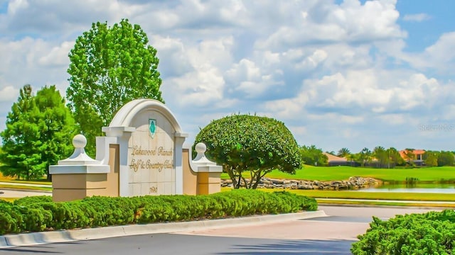 community / neighborhood sign with a water view