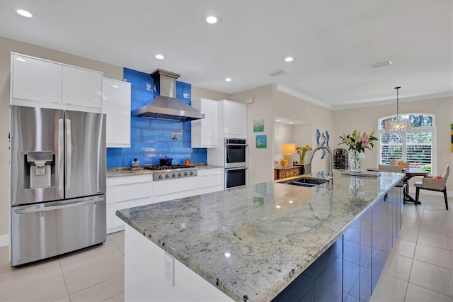 3301 River Woods Dr, Parrish, FL 34219 - kitchen featuring appliances with stainless steel finishes, a sink, wall chimney range hood, light tile patterned floors, and white cabinetry
