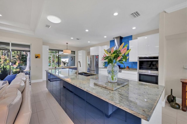 3301 River Woods Dr, Parrish, FL 34219 - kitchen with stainless steel appliances, a sink, a large island with sink, modern cabinets, and recessed lighting