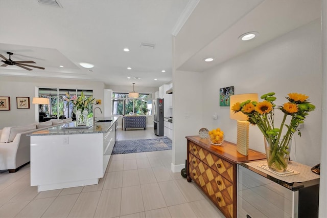 3301 River Woods Dr, Parrish, FL 34219 - kitchen with open floor plan, freestanding refrigerator, recessed lighting, ceiling fan, and a center island with sink