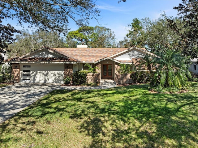 view of front of house featuring a garage, a front lawn, and french doors