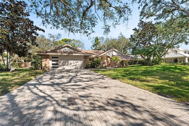 ranch-style home with a garage and a front yard