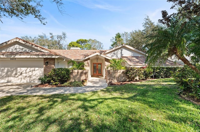 single story home featuring a garage and a front lawn