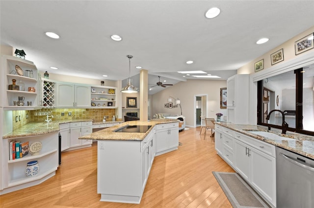 kitchen featuring pendant lighting, sink, dishwasher, a kitchen island with sink, and white cabinets