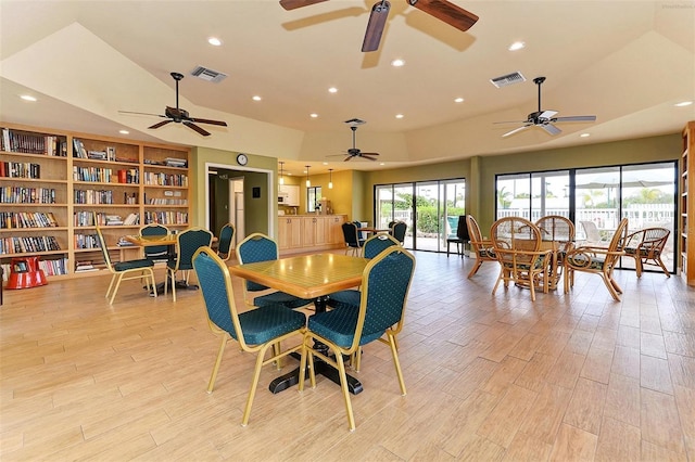 dining space featuring lofted ceiling and light hardwood / wood-style flooring