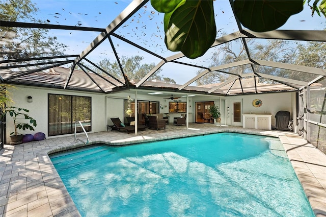 pool with an outdoor living space, ceiling fan, a lanai, and a patio area