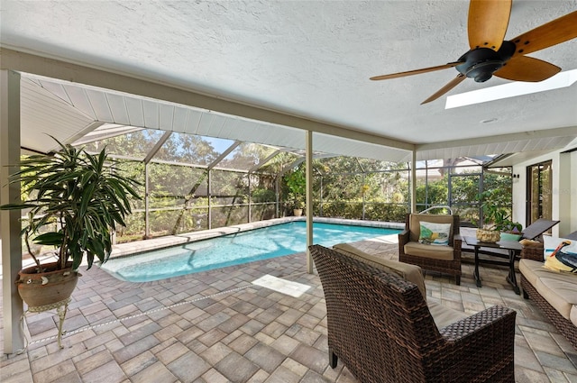 pool with a patio, an outdoor living space, ceiling fan, and a lanai