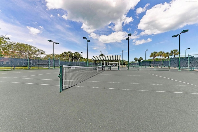 view of tennis court with fence
