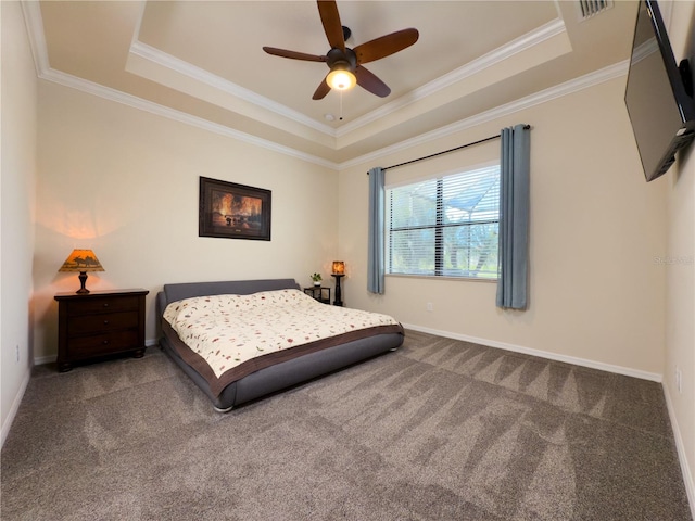 carpeted bedroom with baseboards, a raised ceiling, and crown molding