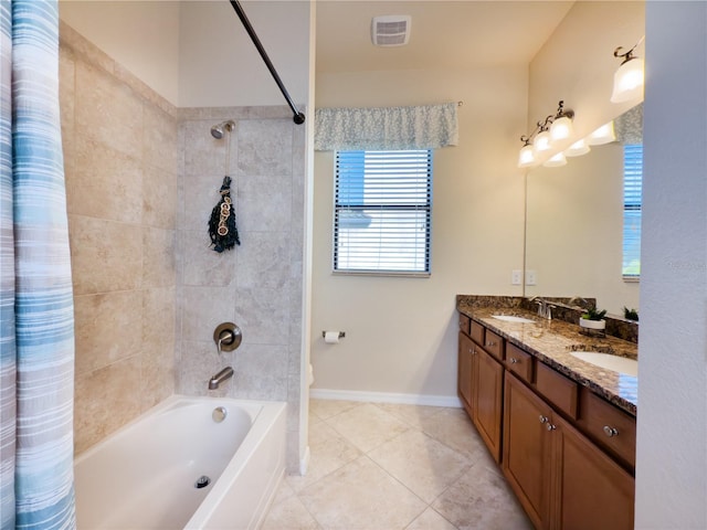 bathroom with double vanity, shower / tub combo, a sink, and baseboards