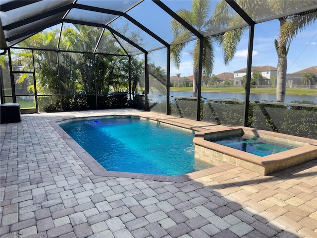 view of pool featuring glass enclosure, a patio area, and a water view