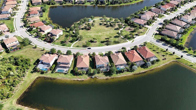 drone / aerial view with a residential view and a water view