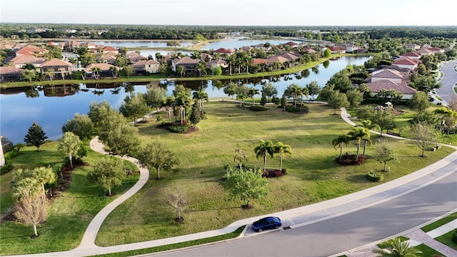 drone / aerial view featuring a water view and a residential view