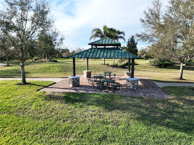 view of home's community with a lawn, a gazebo, and a patio