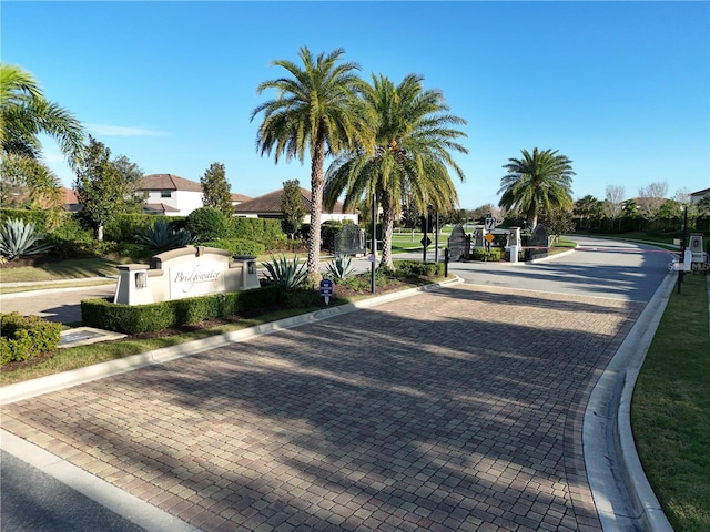 view of street with curbs and a gated entry