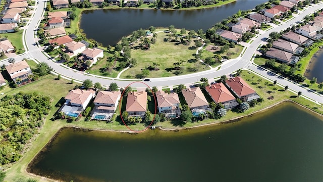 drone / aerial view featuring a residential view and a water view