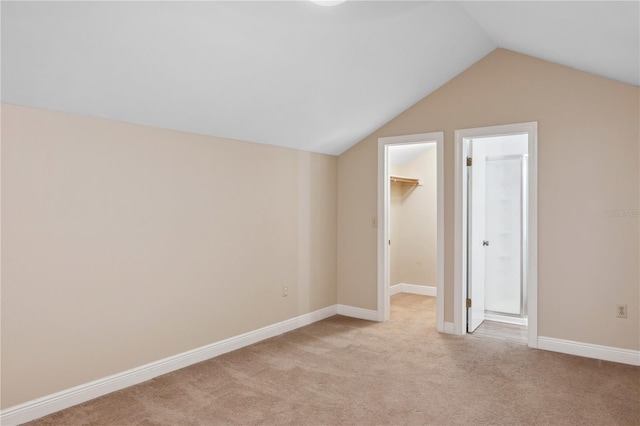 bonus room featuring lofted ceiling, light carpet, and baseboards