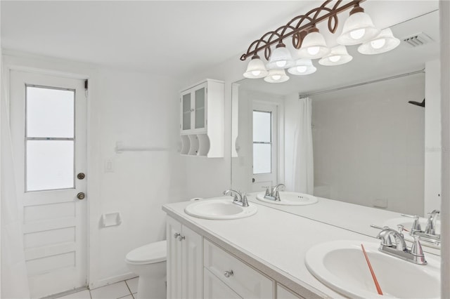 full bathroom with toilet, tile patterned floors, and double vanity