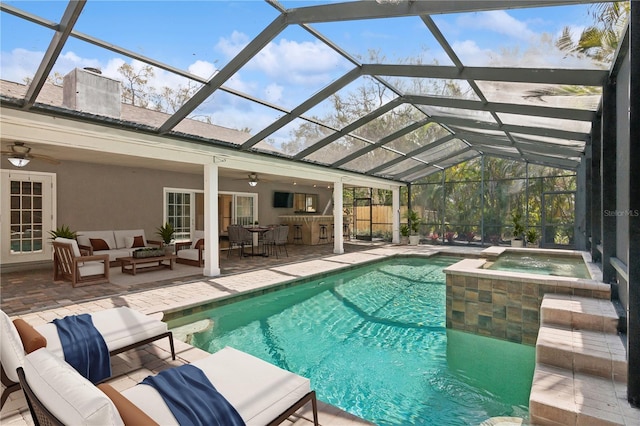 view of swimming pool featuring outdoor lounge area, ceiling fan, a patio, and a pool with connected hot tub