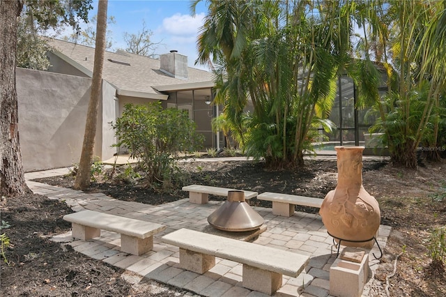 view of patio featuring a sunroom