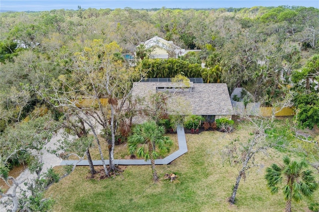 aerial view of property and surrounding area with a heavily wooded area