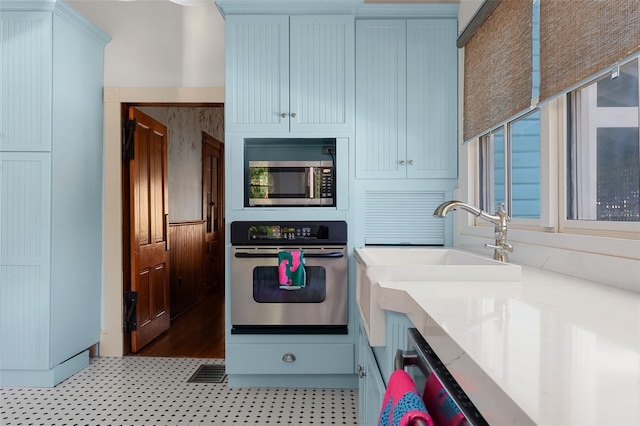 kitchen featuring stainless steel appliances and white cabinets