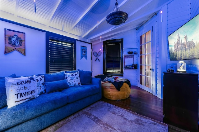 cinema room featuring hardwood / wood-style flooring and vaulted ceiling with beams