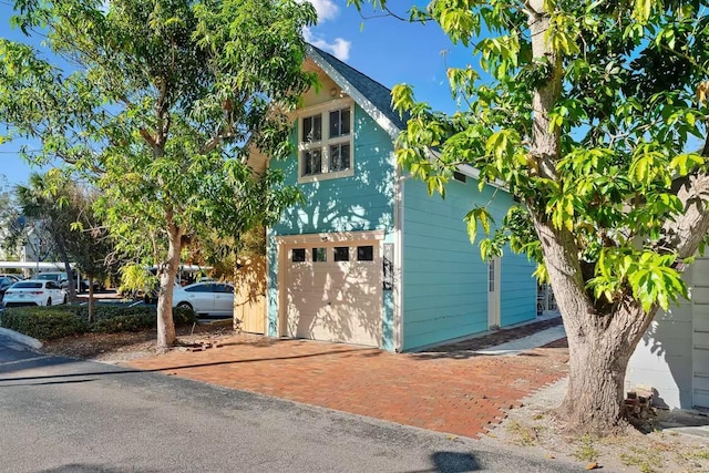 view of side of home featuring a garage