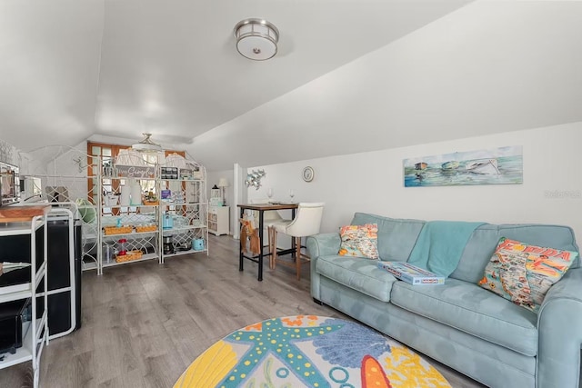 living room with lofted ceiling, hardwood / wood-style floors, and ceiling fan