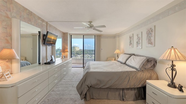 bedroom featuring ceiling fan, light carpet, access to outside, and a wall of windows