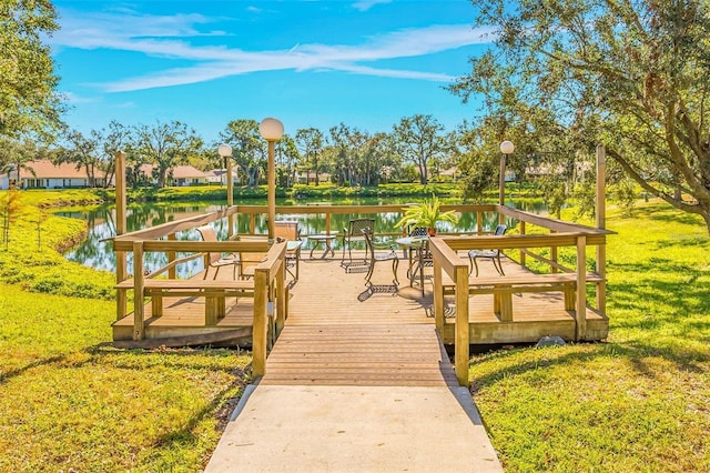 exterior space featuring a water view and a lawn