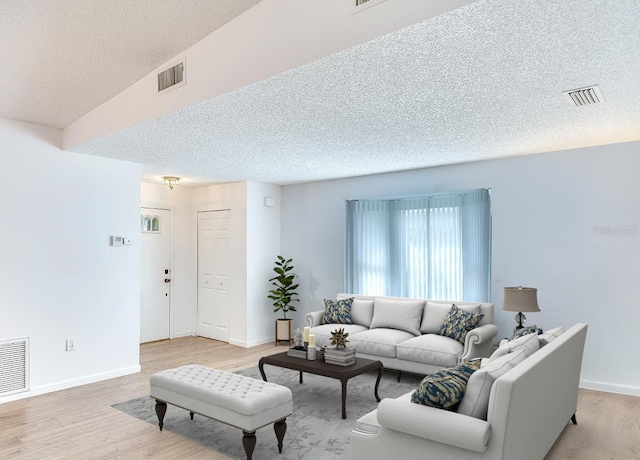 living area with visible vents and light wood-style flooring