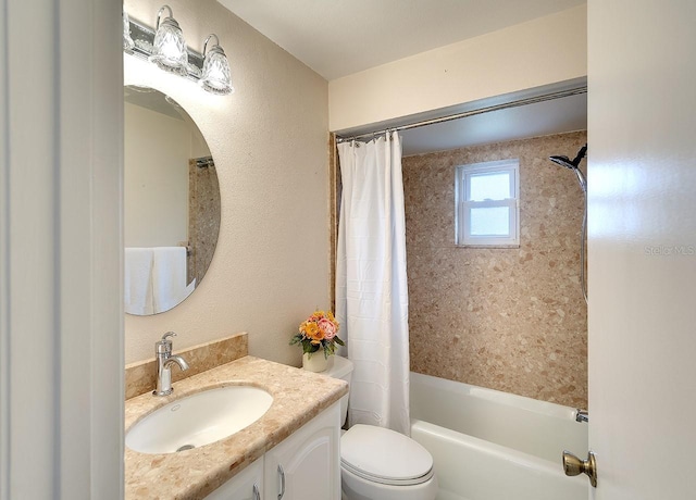 bathroom featuring toilet, vanity, a textured wall, and shower / bathtub combination with curtain