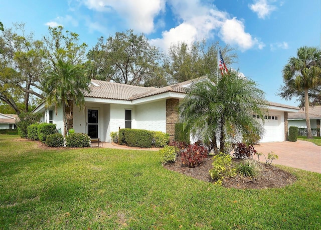 single story home with a tiled roof, a front yard, stucco siding, decorative driveway, and a garage