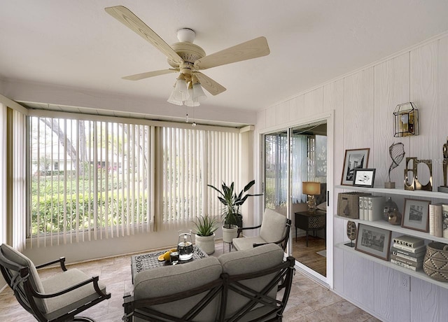 living area featuring a healthy amount of sunlight and ceiling fan