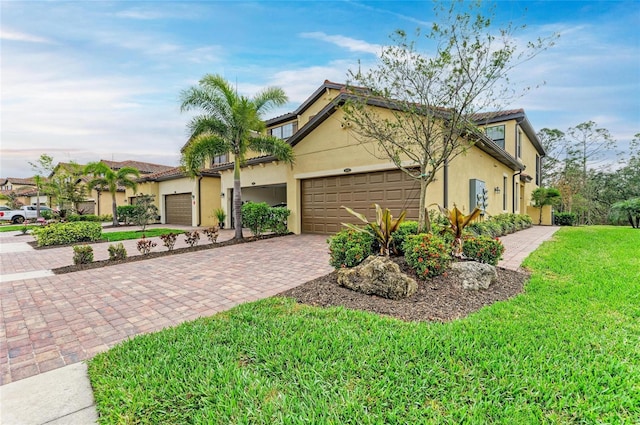 view of front of home with a garage and a front yard