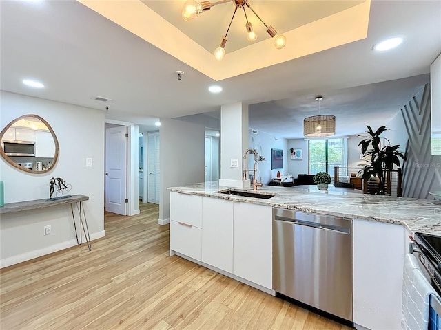 kitchen featuring sink, white cabinetry, light stone counters, appliances with stainless steel finishes, and light hardwood / wood-style floors