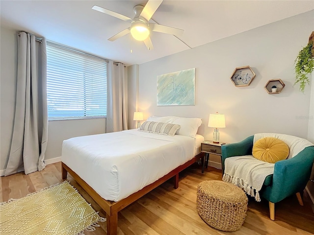 bedroom with ceiling fan and light hardwood / wood-style flooring