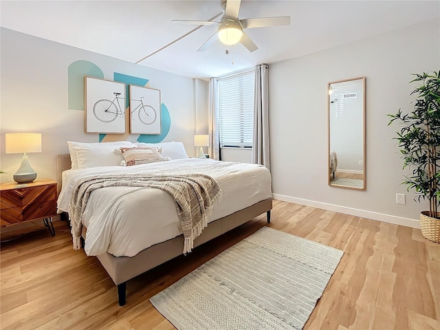 bedroom with light hardwood / wood-style flooring and ceiling fan