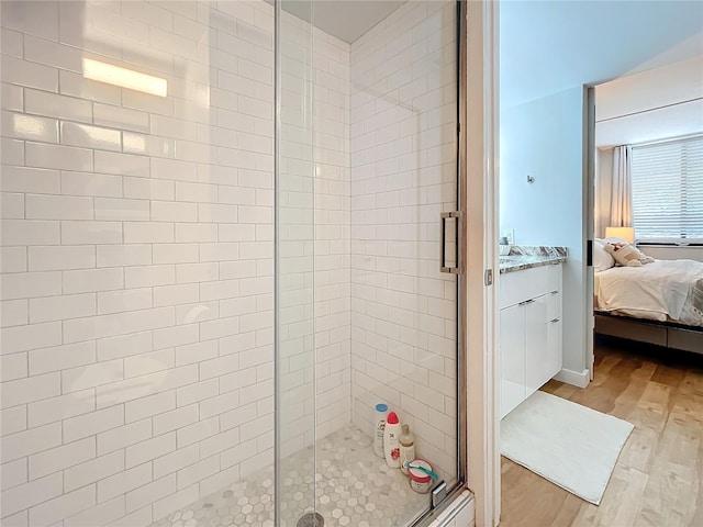 bathroom featuring an enclosed shower and hardwood / wood-style floors