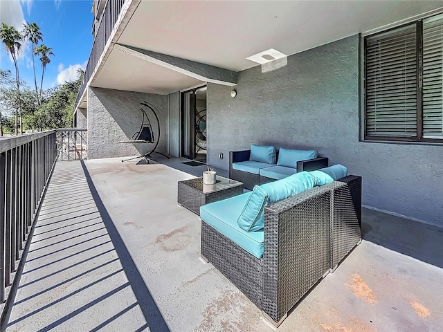 view of patio featuring outdoor lounge area and a balcony